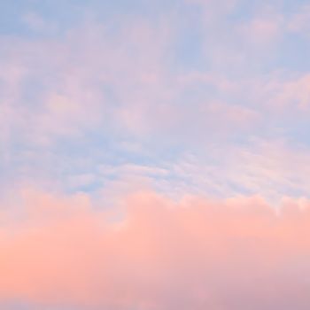 Background of blue sky with pale pink clouds in sunset