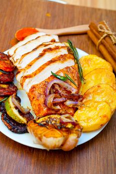 roasted grilled BBQ chicken breast with herbs and spices rustic style