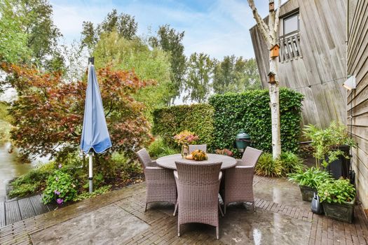 Courtyard with full of greenery and wicker chairs