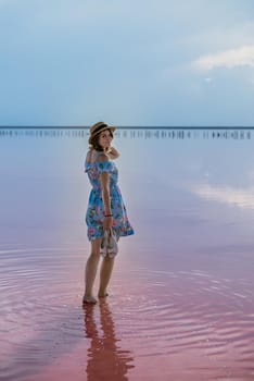 girl posing at sunset on the famous pink salt lake. reflection in the lake.