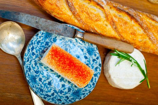 French cheese and fresh  baguette on a wood cutter