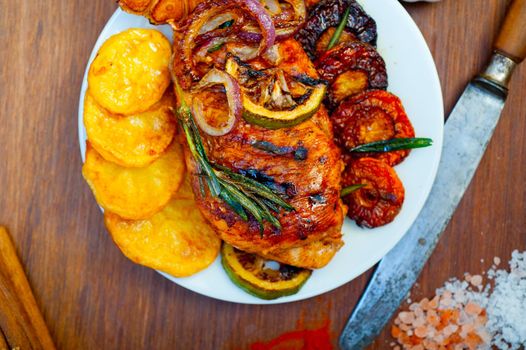 roasted grilled BBQ chicken breast with herbs and spices rustic style