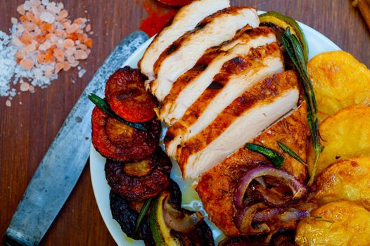 roasted grilled BBQ chicken breast with herbs and spices rustic style