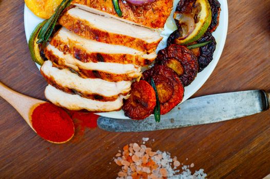 roasted grilled BBQ chicken breast with herbs and spices rustic style