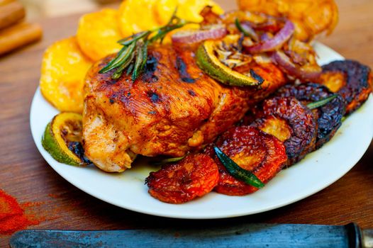 roasted grilled BBQ chicken breast with herbs and spices rustic style