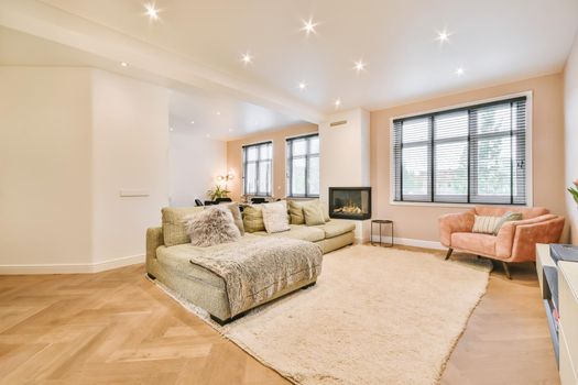 Stylish and cozy living room with soft green soft huge sofa