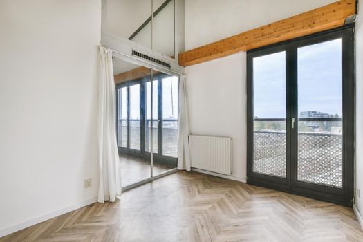 Small cozy room with large double-sash windows on the whole wall