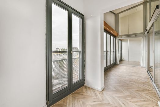 Small cozy room with large double-sash windows on the whole wall