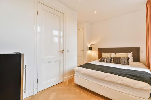 Elegant and cozy bedroom with a double soft bed