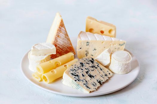 cheese plate with different types of french cheese on white background