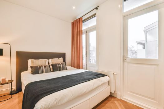 Elegant and cozy bedroom with a double soft bed