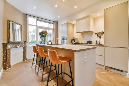 Table in the middle of the kitchen with chairs next to long legs