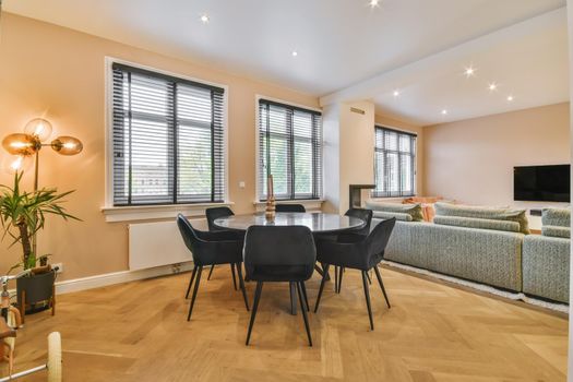 Stylish and cozy dining area with a round black table and black chairs