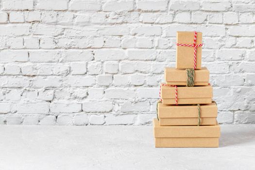 Craft paper gift boxes on the brick wall background, zero waste concept, copy space