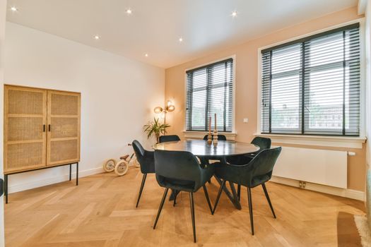 Stylish and cozy dining area with a round black table and black chairs