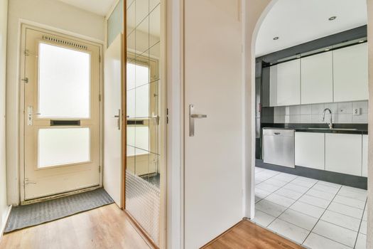 Interior of the light kitchen with modern appliances in a modern flat at daytime