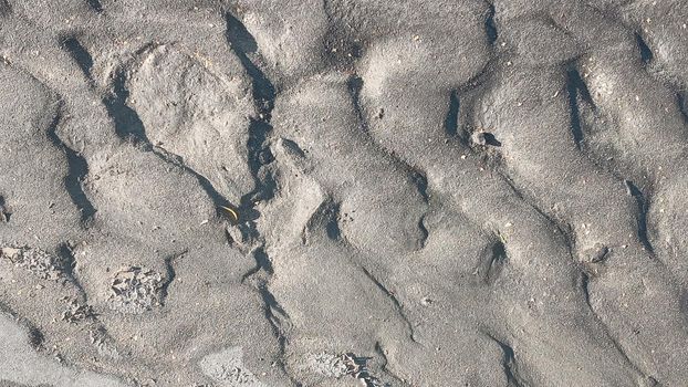 Dirty wet sand, grunge horizontal shabby background close-up. Blurry image of sand pattern. Abstract nature background.