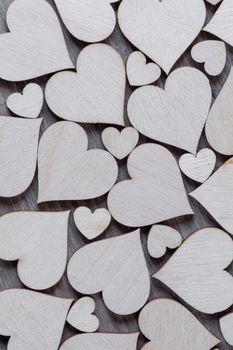 Background of many decorative wooden hearts as a festive Valentine day background