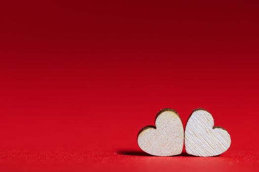 Valentines day red background with two wooden hearts