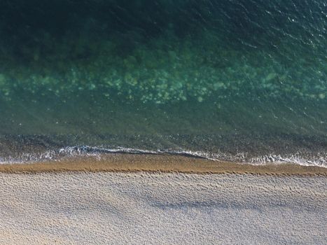 Aerial panoramic view of beautiful sunset above sea. Beautiful seascape. Sun glare, small waves on the water surface. Evening. Horizon. Nobody. No people. Copy space. Never-ending beauty of nature