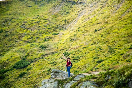 Girl Descend Down a Large Green Mountain Range.