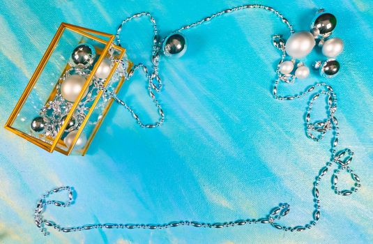 silver Christmas toys and garland on blue background, top view, flat lay, copy space. new year frame. High quality photo