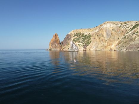 Aerial panoramic view of beautiful sunset above sea. Beautiful seascape. Sun glare, small waves on the water surface. Evening. Horizon. Nobody. No people. Copy space. Never-ending beauty of nature
