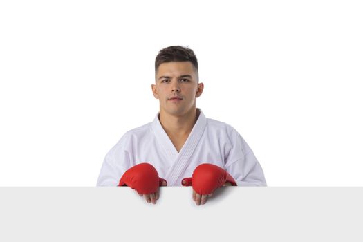 Man fighter training taekwondo with blank banner isolated on white background