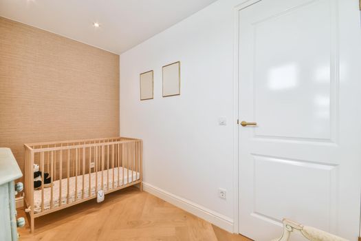 Cozy children's room in the daylight with a small crib