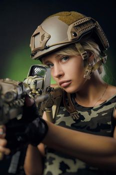 soldier girl poses with an automatic rifle