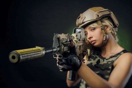 soldier girl poses with an automatic rifle