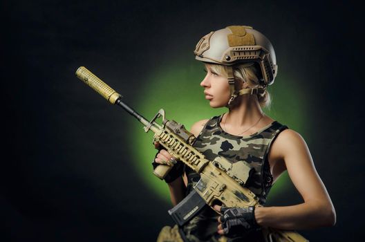 soldier girl poses with an automatic rifle