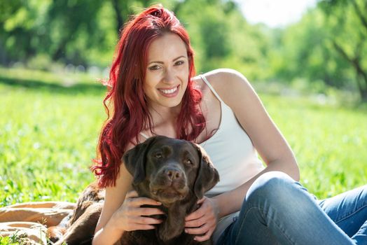 Woman in the park hugs a dog. Spend time with pets