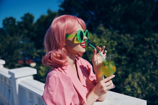 cheerful woman enjoying a colorful cocktail hotel terrace Relaxation concept. High quality photo
