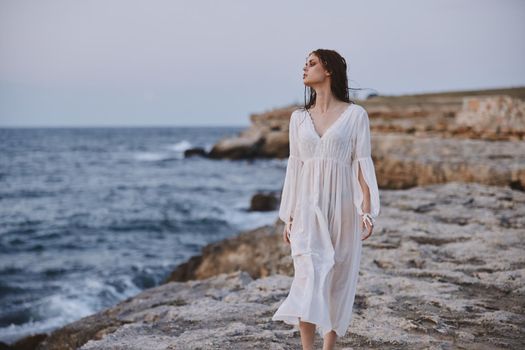 Beautiful woman white dress standing outdoor freedom unaltered. High quality photo