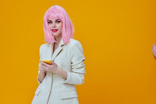 smiling pretty woman pink wig suit phone technology. High quality photo