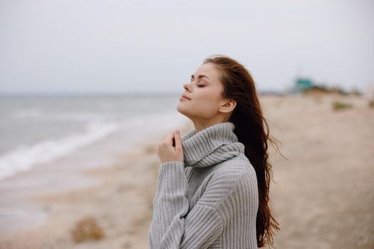 portrait of a woman red hair in a sweater by the ocean unaltered. High quality photo