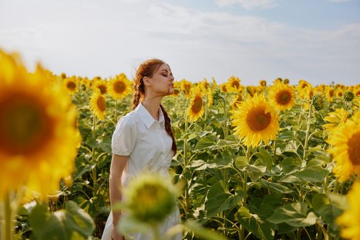 woman with two pigtails in a white dress admires nature countryside. High quality photo