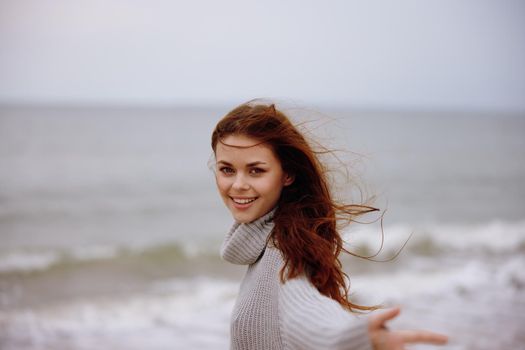 pretty woman with long hair on the beach nature landscape walk Relaxation concept. High quality photo