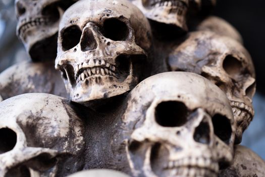 Skull Halloween Background Many People Skulls Stand on top of each other. Mystic creepy concept. Abstract nightmare occult memorial.