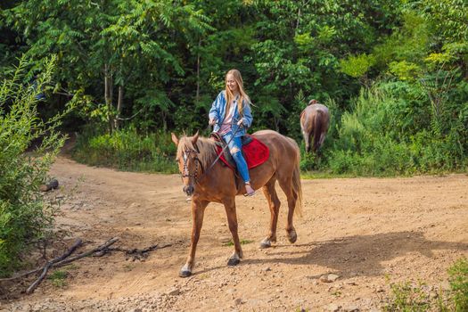 Beautifulwoman riding a horse in countryside.