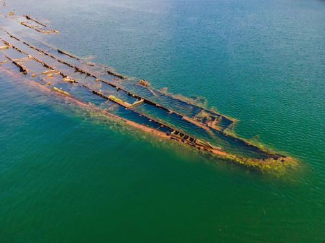 Abandoned broken shipwreck sticking out of the sea.