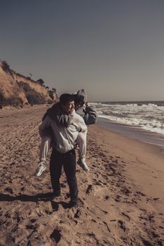 A man and a woman enjoy each other on the seashore. Have fun together