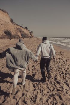 A man and a woman enjoy each other on the seashore. Have fun together