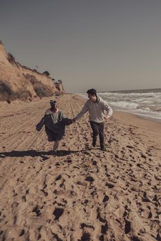 A man and a woman enjoy each other on the seashore. Have fun together