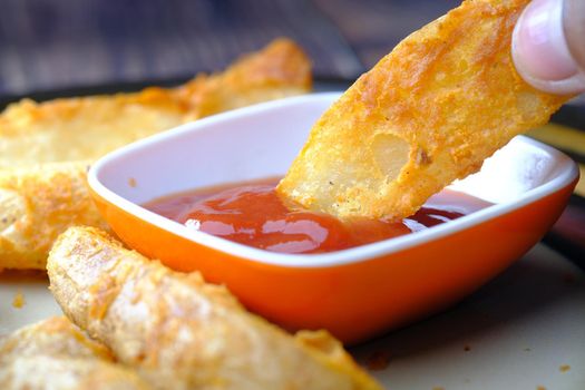 Tasty freshly made wage potato chips in a plate .