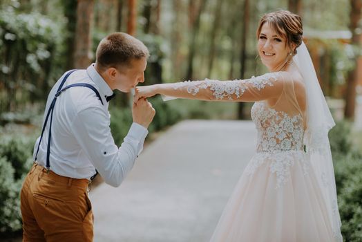 Sensual portrait of a young couple. Wedding photo outdoor. Wedding shot of bride and groom in park. Just married couple embraced