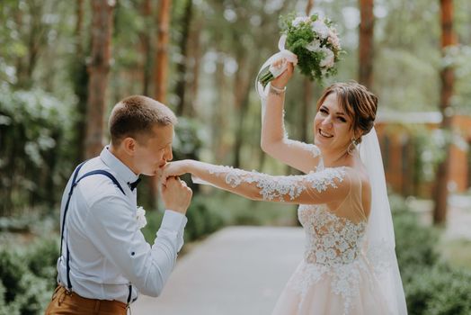 Sensual portrait of a young couple. Wedding photo outdoor. Wedding shot of bride and groom in park. Just married couple embraced