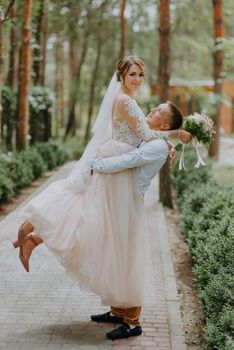 Sensual portrait of a young couple. Wedding photo outdoor. Wedding shot of bride and groom in park. Just married couple embraced