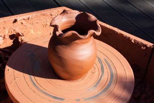 making anshaping up the clay of the pot